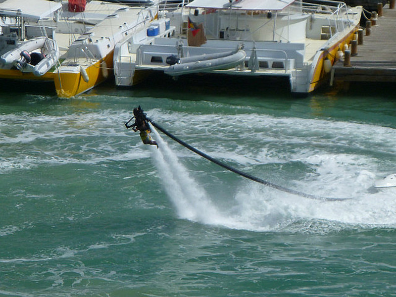 man riding high on water jets