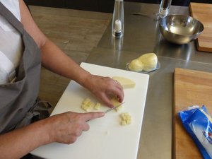 Cutting the cheese into small chunks