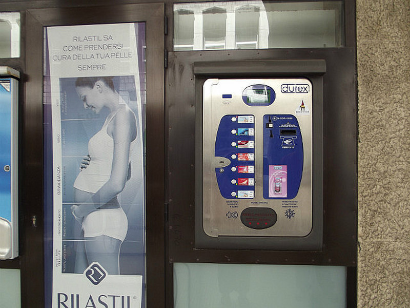 Condom machine next to an OB ad!  