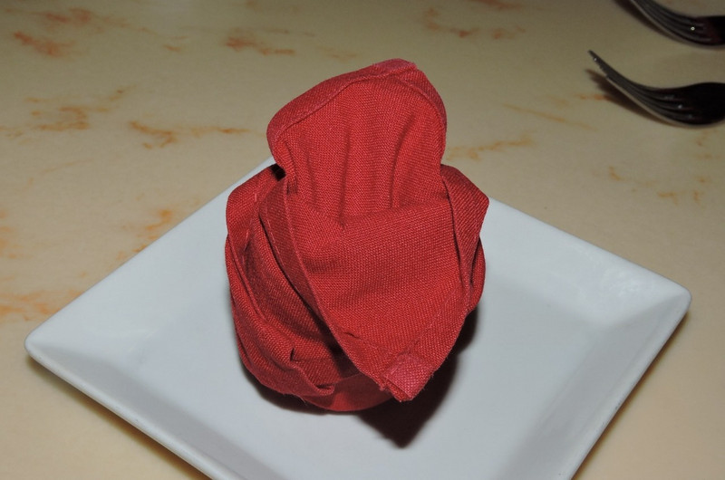 Red rose napkin at Be Our Guest Restaurant