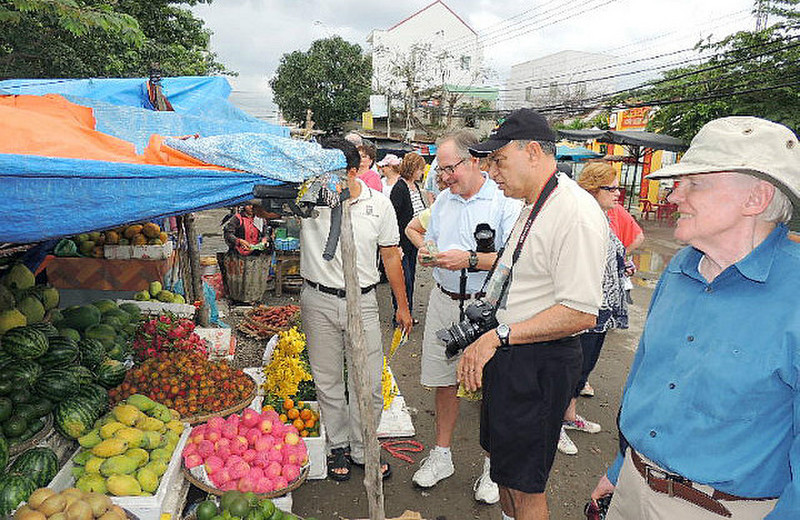 Tauck travelers bargaining for fruit