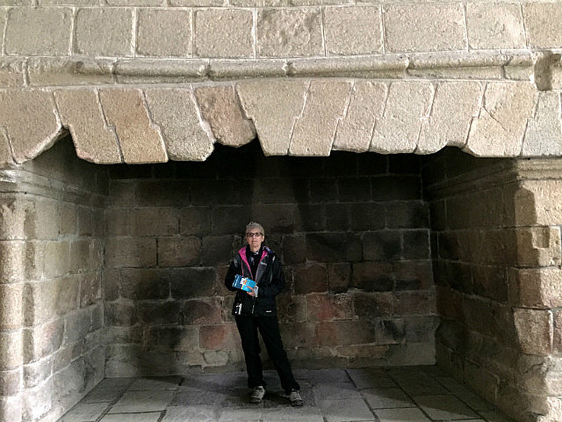 Dot standing in the giant fireplace