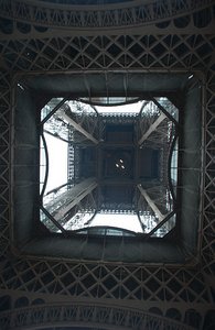Looking up the middle of the Eiffel Tower