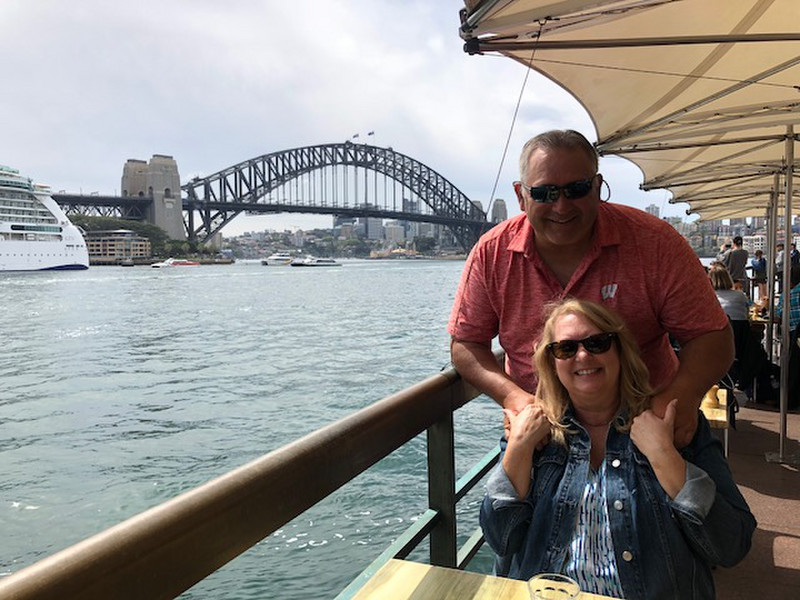 Karen and I having lunch with the Harbor bridge in the background_ when we return we will climb to the top