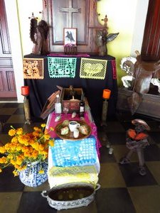 Day of the Dead display includes food, pictures, drink and even toys.