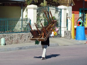 The xylophone playing balloon seller carries it around town all day.