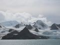 Glaciers moving between peaks down to sea