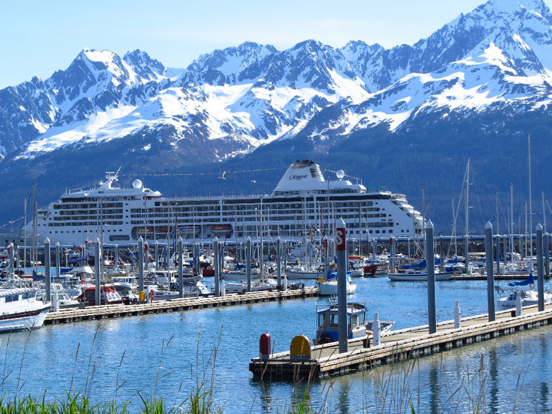 Seward small boat harbour with cruise ship behind.