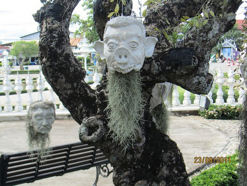 Heads hanging from tree at White Temple