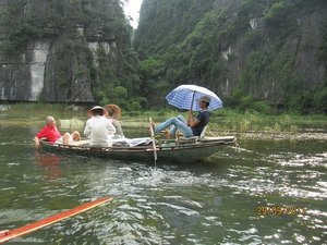 Man rowing down river with feet
