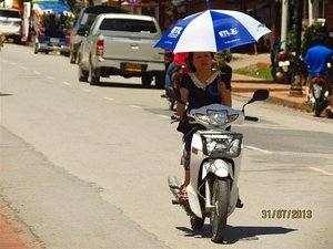 Most use umbrellas as sunshades on bikes
