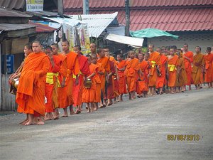 Monks gathering alms in bowls