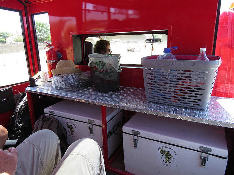 Inside our big red bus, cool boxes for beer!