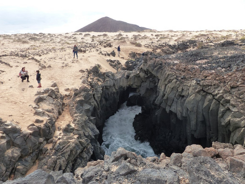 Sea entering below the lava and sand