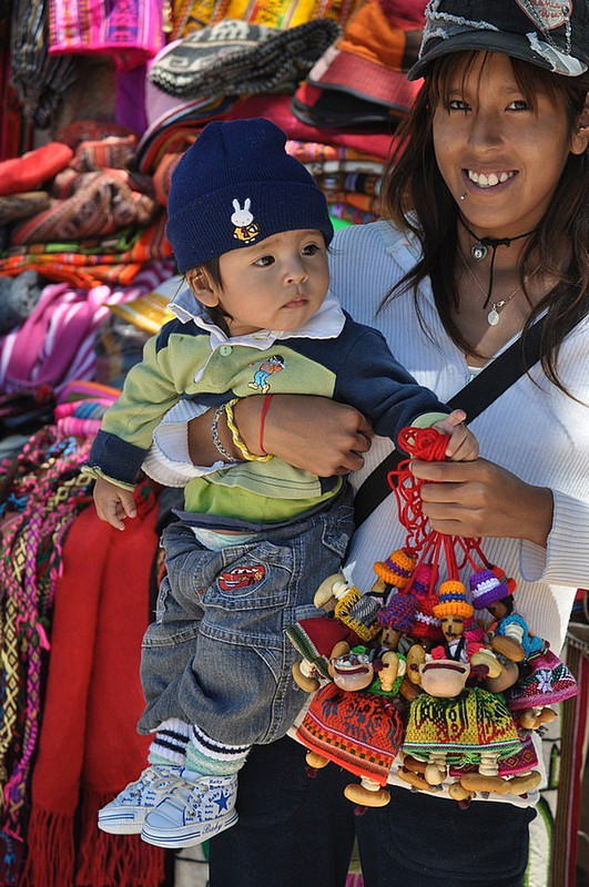 Bolivian girl brings baby to work