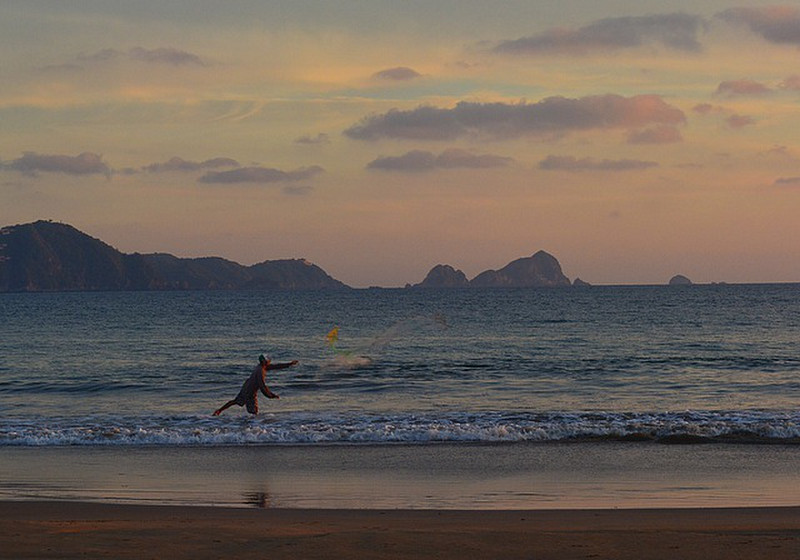 Lone fisherman tosses a net