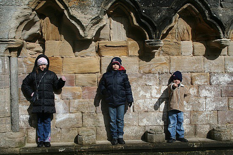 The kids being statues on the cathedral wall