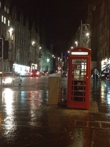 The red phone boxes still stand out at night