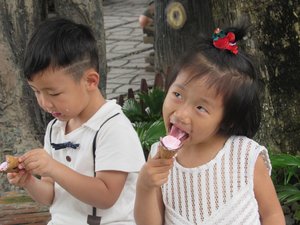 2 kids eating icecream - look at their faces