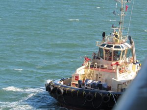 Tug Boat on each side of the Ship