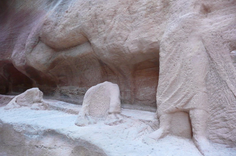 Remains of a carving of a man and camels resting