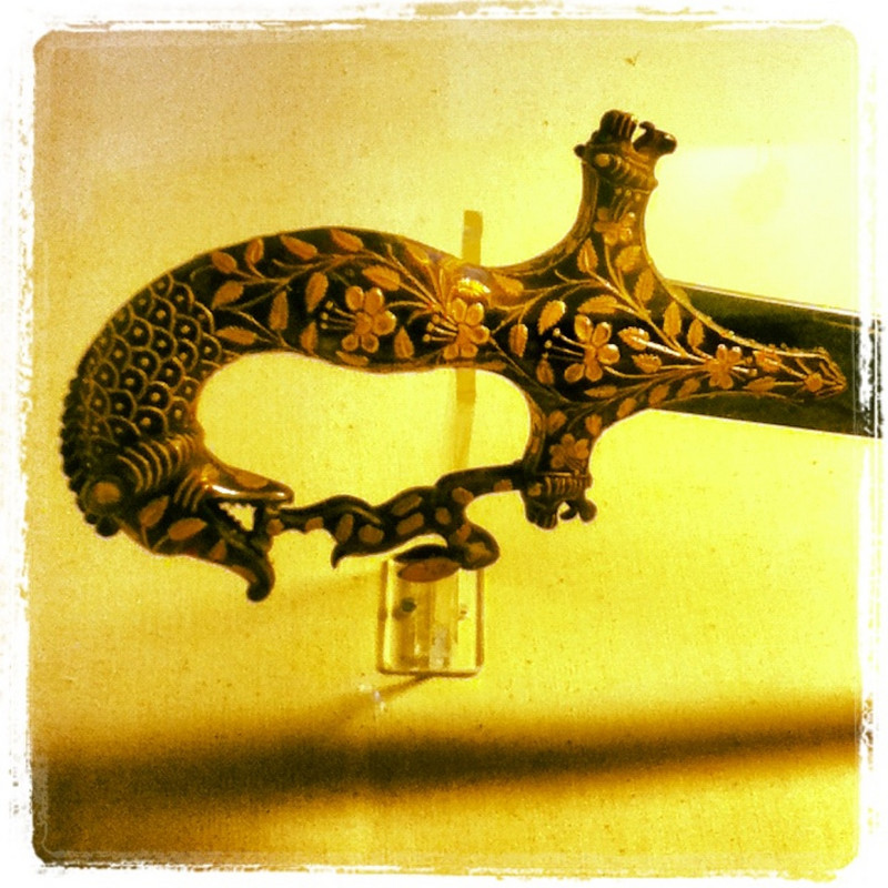 Sword hilt with a dragon catching a rabbit