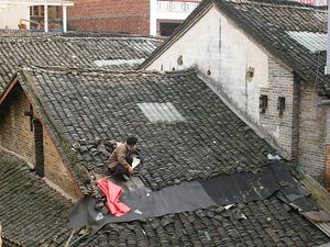 Fixing the roof - as seen from our hotel balcony