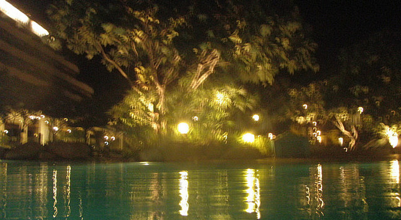 The hotel pool lit up at night