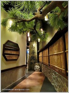Bamboo walls leading to Japanese tree and script