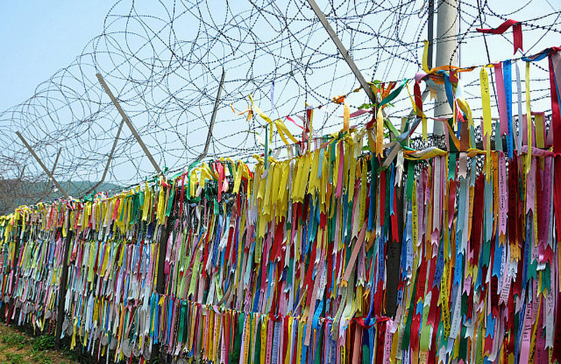 Ribbons On The Razorwire-Topped Fence 