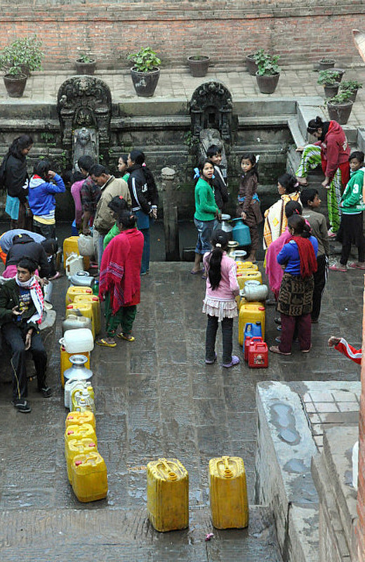 Lining Up For Water From Fountain