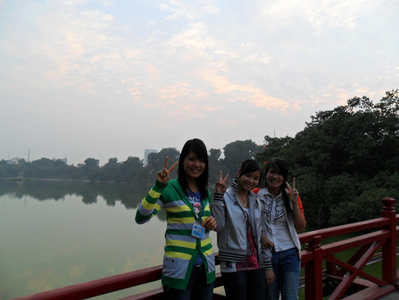 Girls on the bridge of Hoan Kiem lake