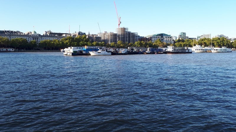 Boats moored in the middle of the Thames