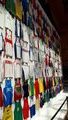 A wall of athletics singlets from all round the world