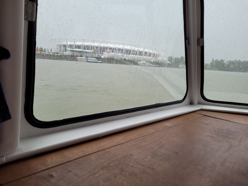 Boat approaching the stadium in the rain