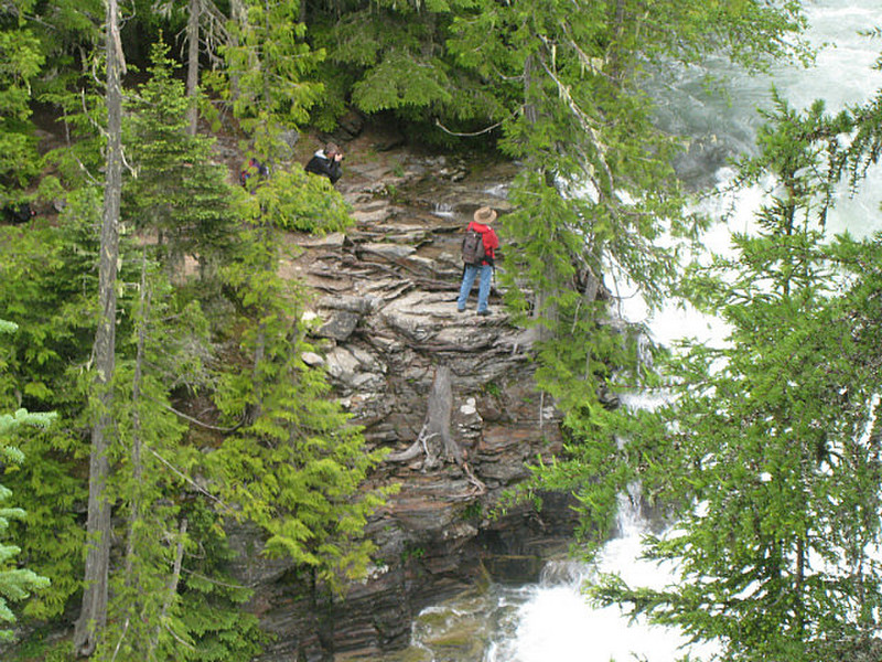 Hiker viewing the falls from across the river