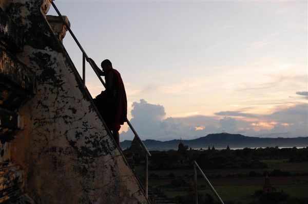 Monk climbing Shwesandaw Paya