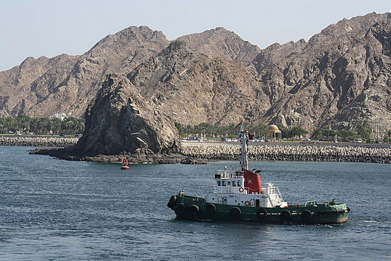A tugboat racing out of Muscat bay