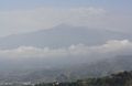 Mount Etna shrouded in a band of low cloud