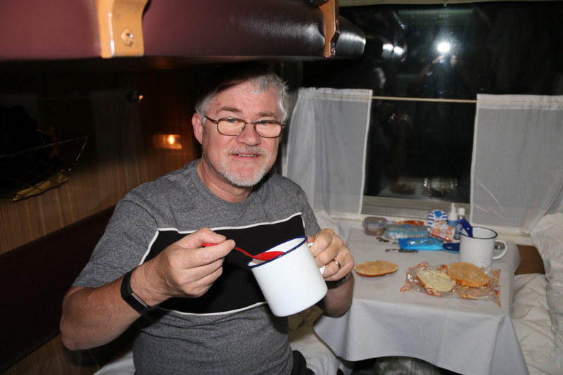 Chris enjoying a mug shot (spicy tomato and noodles!)
