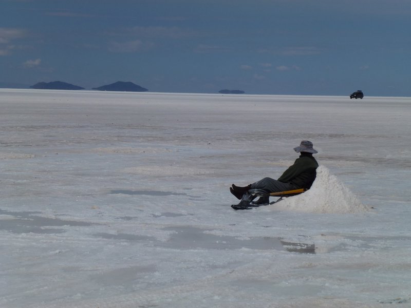 Man laying against a salt mound