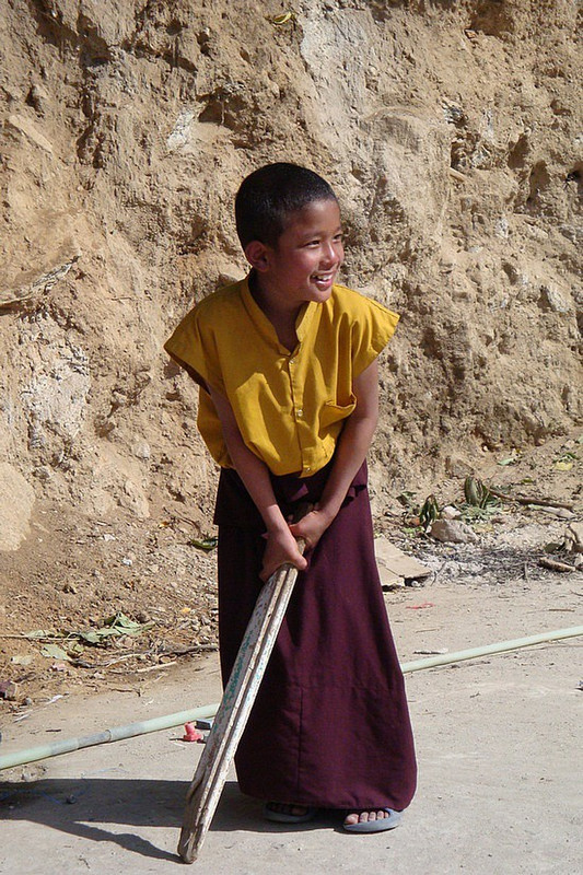 Young Monk Playing Cricket