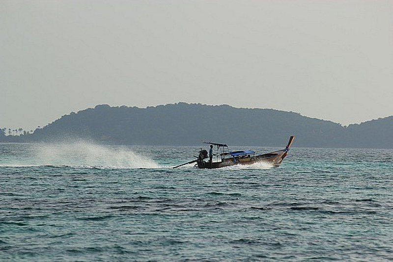 Long Tail Boat Speeding Away