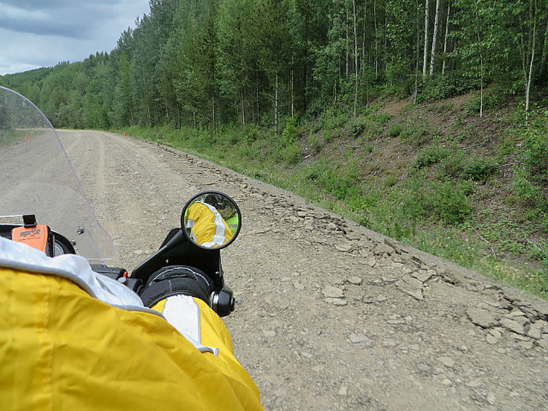 Riding the muddy gravel south of Dease Lake