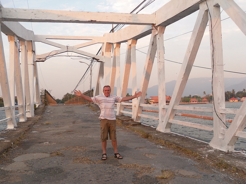 Crossing the old French bridge in Kampot