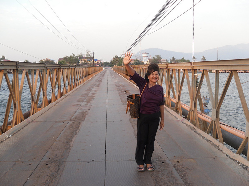 Crossing the old French bridge in Kampot