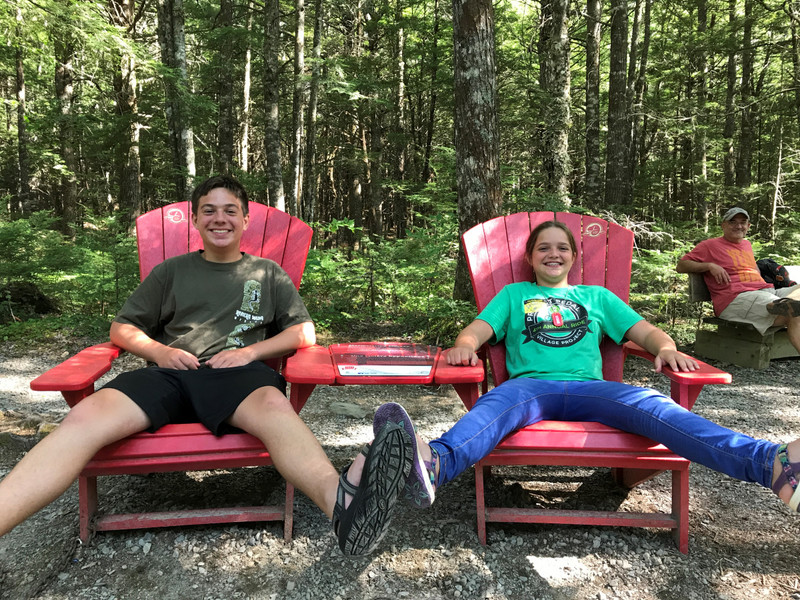 Max and Maggie in red adirondack chairs