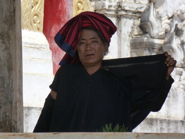 Typical Myanmar hilltribe woman dressed in black wearing a colorful towel on her head