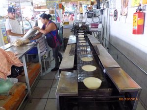 A tortilla machine in the market. 