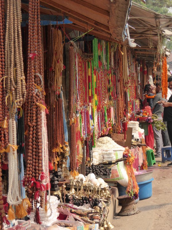 Rows or garlands and beads in stalls outside temple